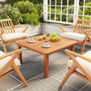 Solid wood patio coffee table with teak oil finish, featuring a slatted top and built-in umbrella hole for outdoor use.