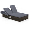 Patio double chaise lounge with gray cushions, adjustable backrests, and folding side trays for backyard relaxation.