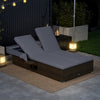 Patio double chaise lounge with gray cushions, adjustable backrests, and folding side trays for poolside relaxation.