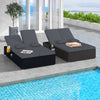 Patio double chaise lounge with gray cushions, adjustable backrests, and folding side trays, perfect for poolside.