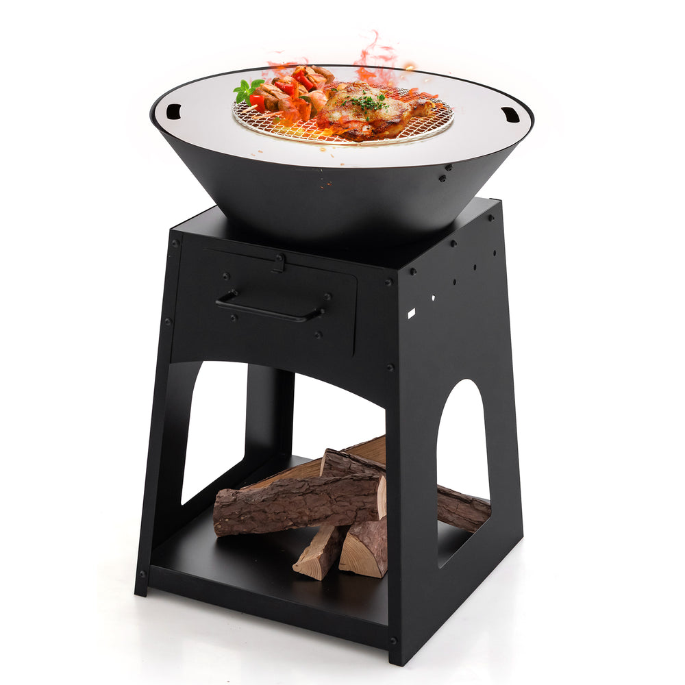 Patio fire pit with grill and ash box, featuring a black metal design and firewood storage for outdoor cooking.