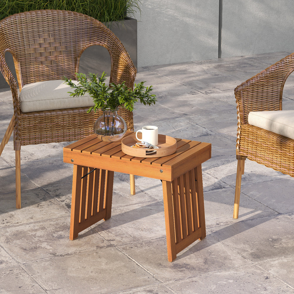 Patio foldable side table with slatted tabletop in acacia wood, perfect for backyard or poolside use.