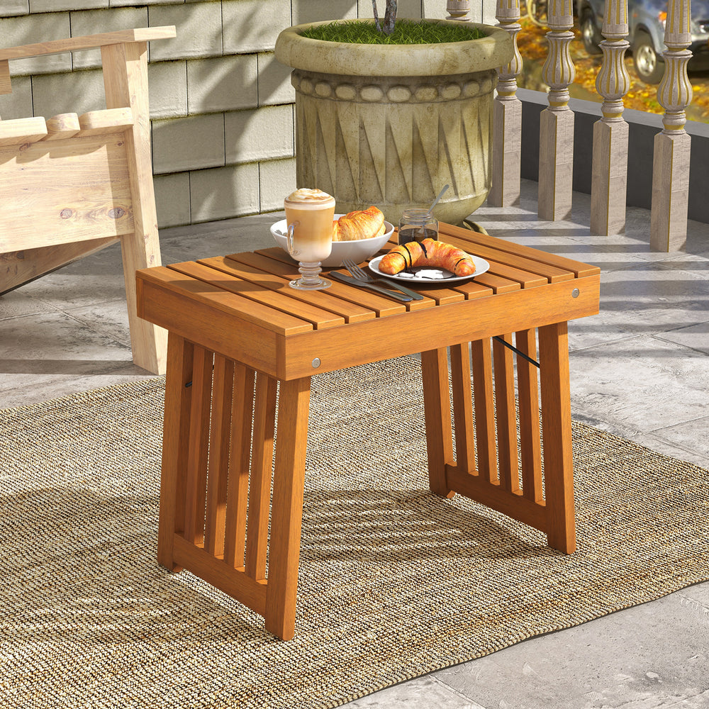 Patio foldable side table made of acacia wood with slatted tabletop, perfect for backyard or poolside use.