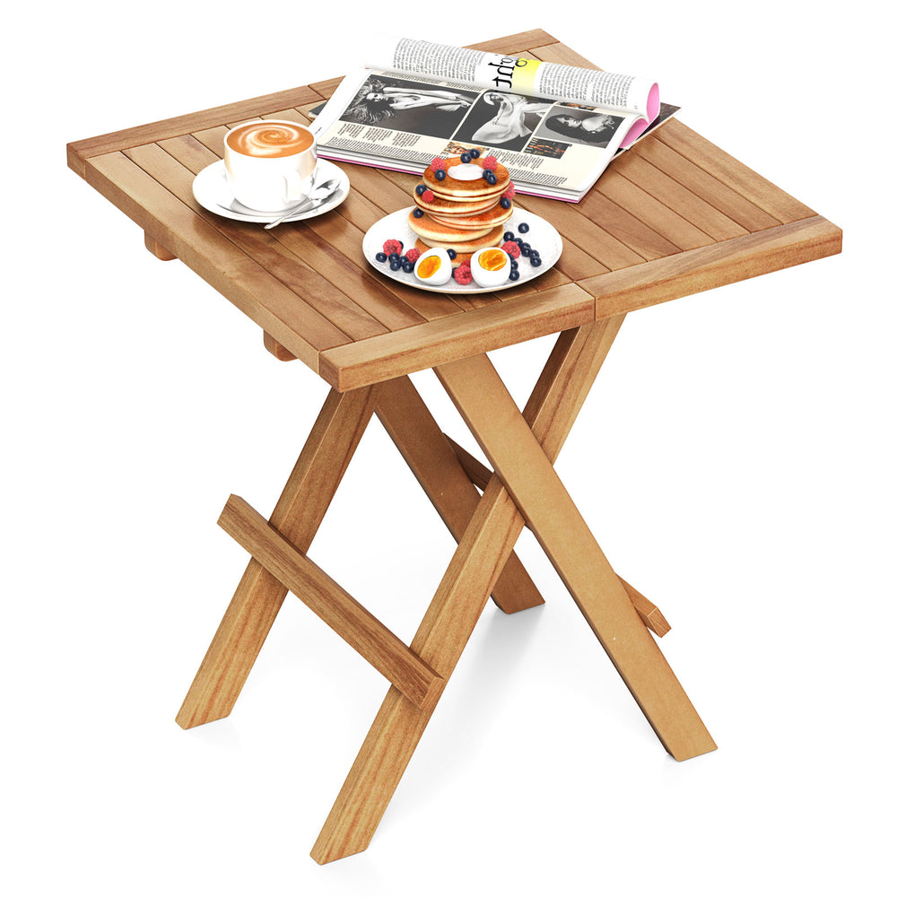 Patio folding side table made of teak wood with slatted tabletop, ideal for camping and backyard use.