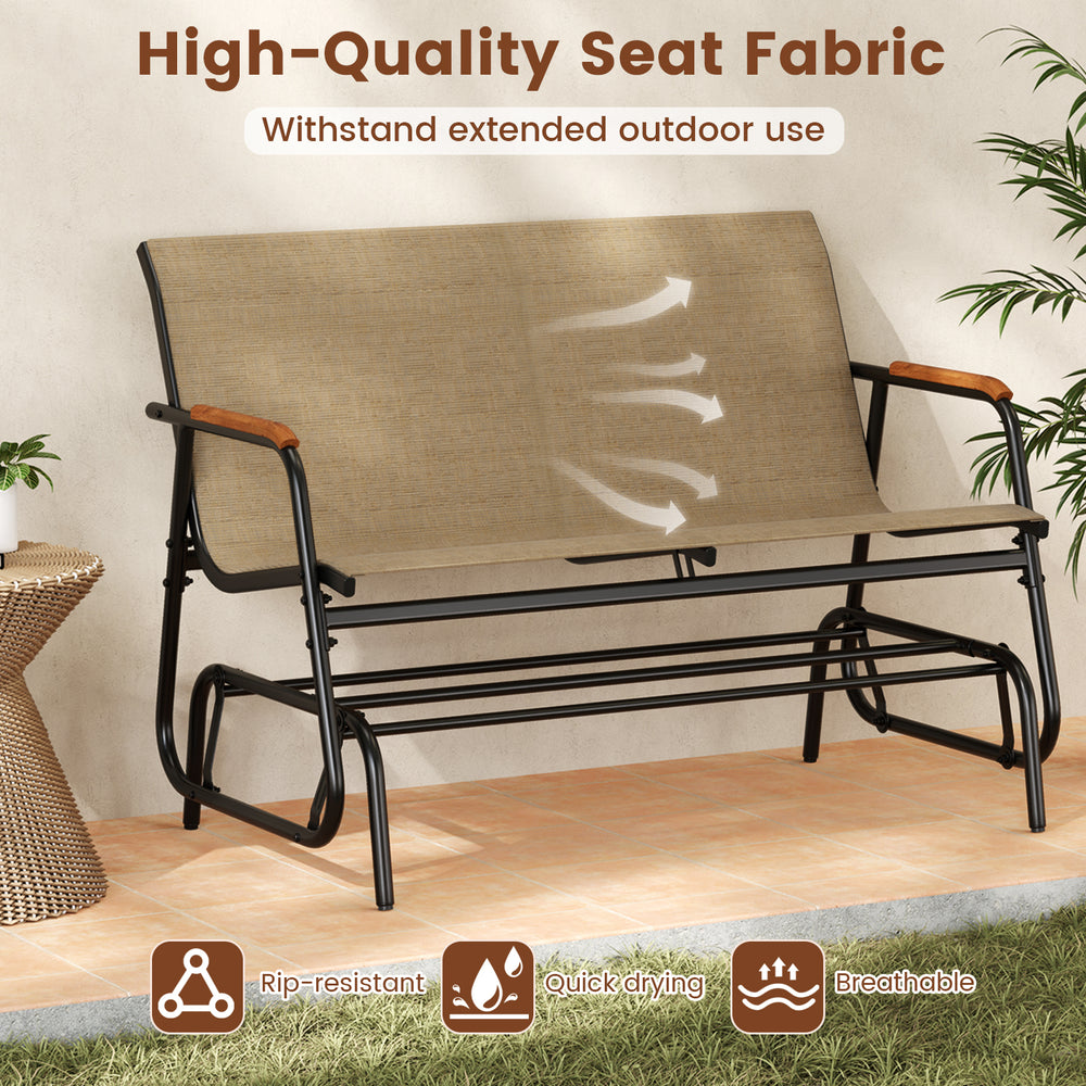 Patio glider bench for 2 with breathable fabric seat and curved teak armrests, perfect for backyard relaxation.