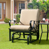Patio glider rocking chair with tan cushion and curved armrests, perfect for outdoor relaxation in any space.