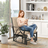 Patio glider rocking chair with thick tan cushion and curved armrests, perfect for outdoor relaxation.