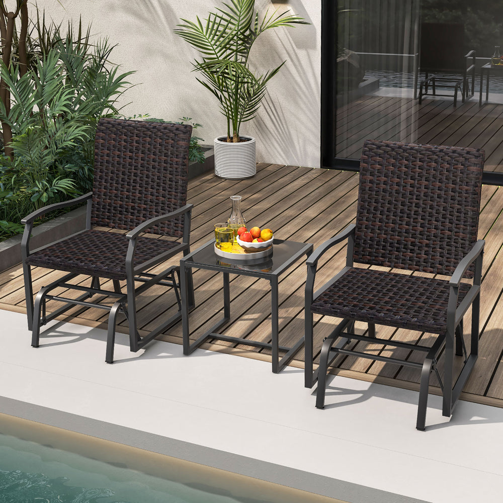 Two brown patio gliding chairs with a tempered glass coffee table, perfect for backyard relaxation by the poolside.