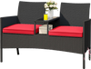 Patio loveseat with integrated table, featuring a sturdy metal frame and zippered red cushions, ideal for outdoor.