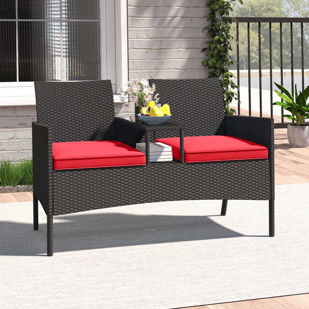 Patio loveseat with built-in table, hand-woven PE rattan, red cushions, perfect for backyard or porch relaxation.
