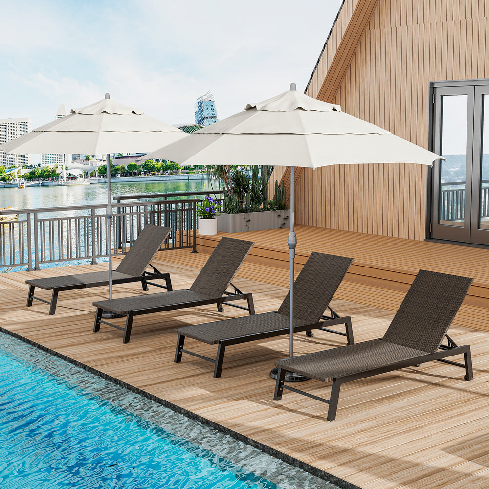 Set of four brown PE rattan chaise lounges with umbrellas, perfect for outdoor relaxation by the poolside.
