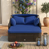 Patio PE rattan daybed with navy cushions and retractable canopy, providing comfort and style for outdoor lounging.
