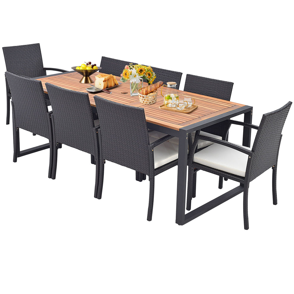 9-piece patio rattan dining set featuring an acacia wood table and soft cushions, ideal for backyard gatherings.