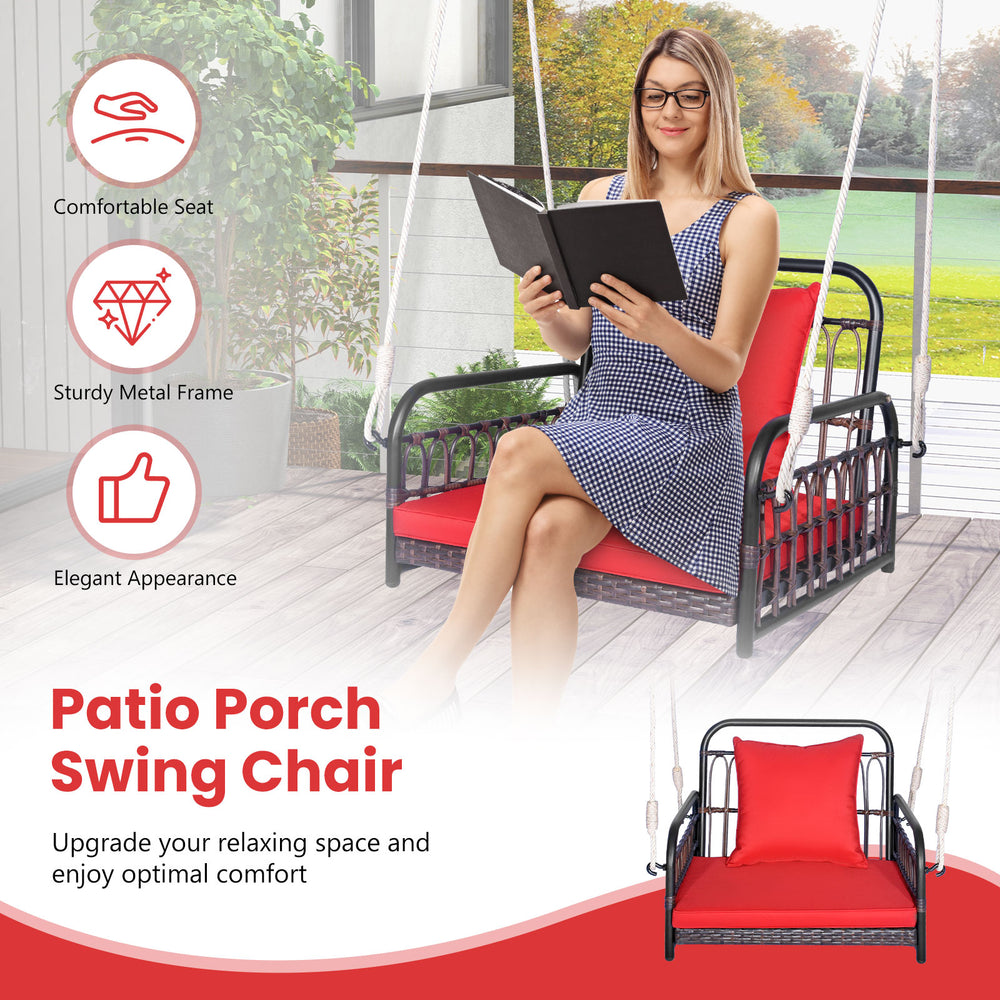 Patio rattan swing chair with red cushion, featuring a sturdy metal frame for backyard relaxation and comfort.