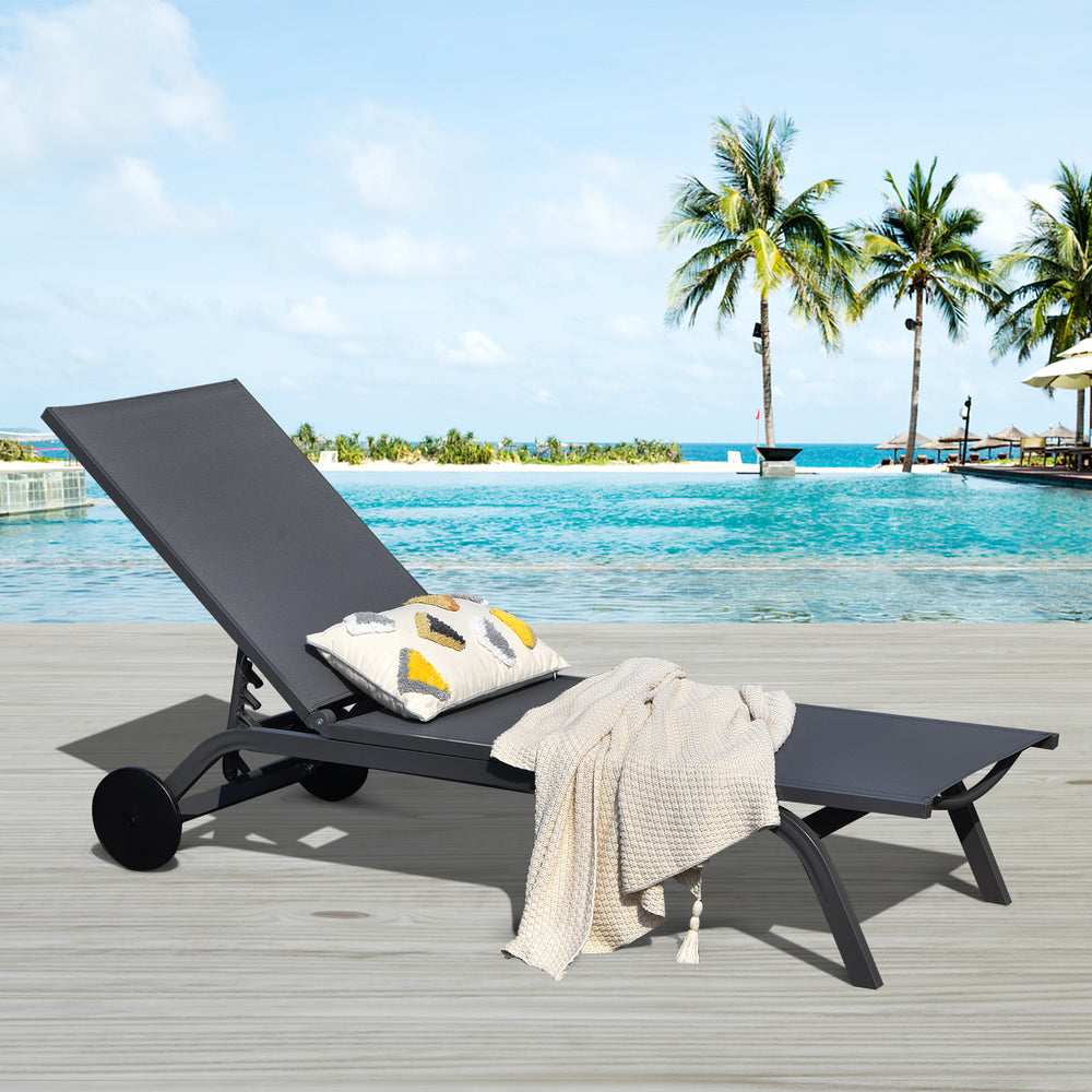 Adjustable gray outdoor patio recliner chair with six positions, perfect for poolside relaxation and easy mobility.