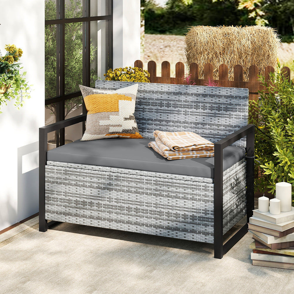 Patio storage bench in gray wicker with built-in storage, ideal for backyard seating and organization.