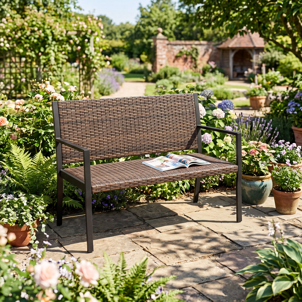 Brown patio loveseat made of sun-proof rattan with soft sponge seat, perfect for garden relaxation.