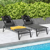 Two black patio sunbathing lounge chairs with adjustable backrests and pillows, ideal for poolside relaxation.