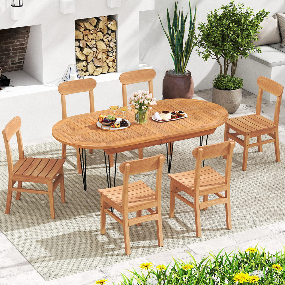 Teak wood armless dining chairs with slatted seats around an oval table, perfect for backyard or poolside dining.