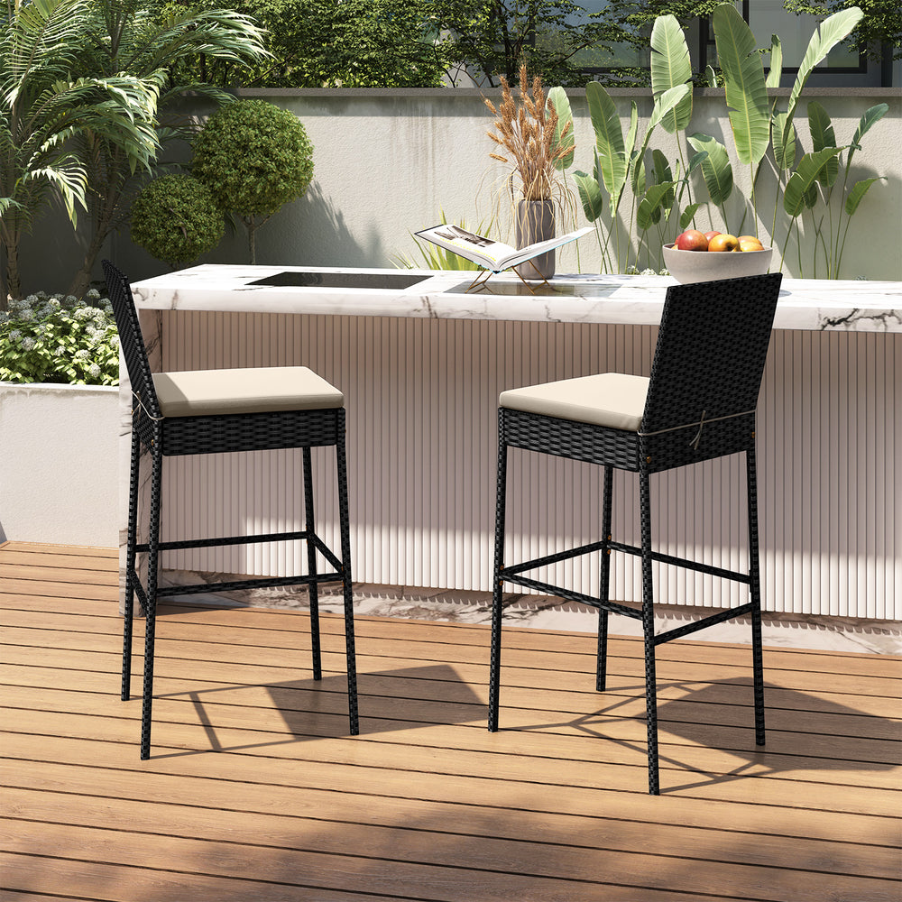 Set of two patio wicker barstools with backrest and footrest, featuring beige cushions for outdoor relaxation.