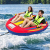 Two people enjoying the 1 or 2 Person Inflatable Towable Tube for Boating on the water, featuring thick padded handles.