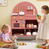 Wooden play kitchen set in pink with stoves, sink, and accessories, designed for imaginative cooking fun for kids.
