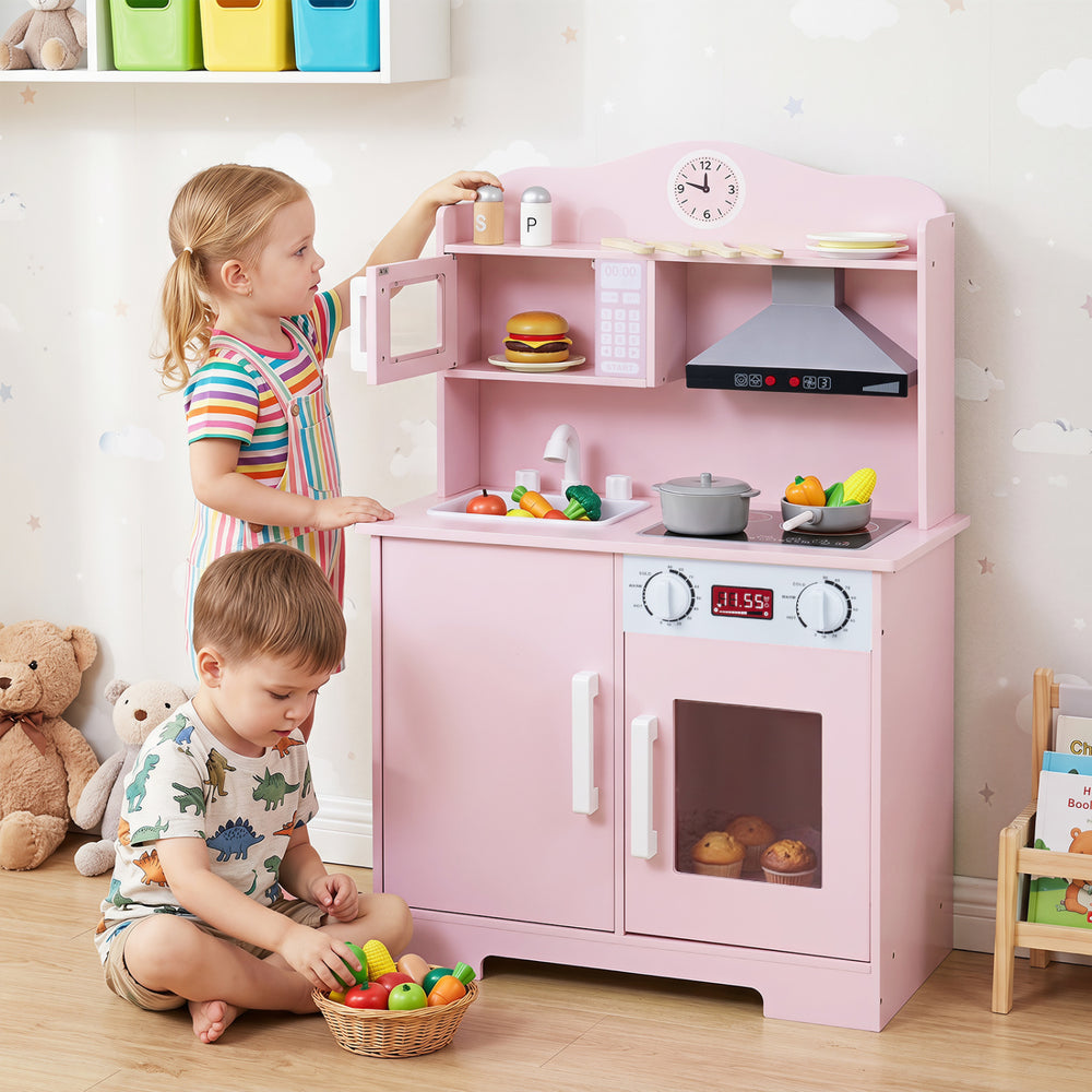 Wooden pink play kitchen set for kids featuring a range hood, microwave, and realistic cooking accessories for imaginative play.