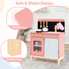 Wooden play kitchen for kids in pink with rounded edges, solid wood legs, and organized storage for imaginative play.