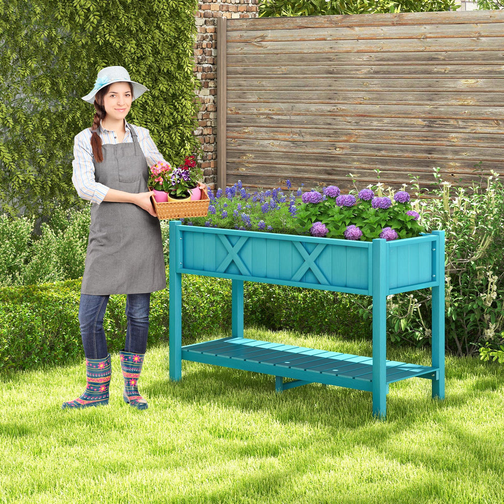 Elevated blue planter box with legs, featuring drainage holes and a storage shelf, ideal for growing flowers and herbs.
