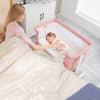 Portable pink bedside bassinet with adjustable height, breathable mesh, and soft mattress for safe baby sleeping.