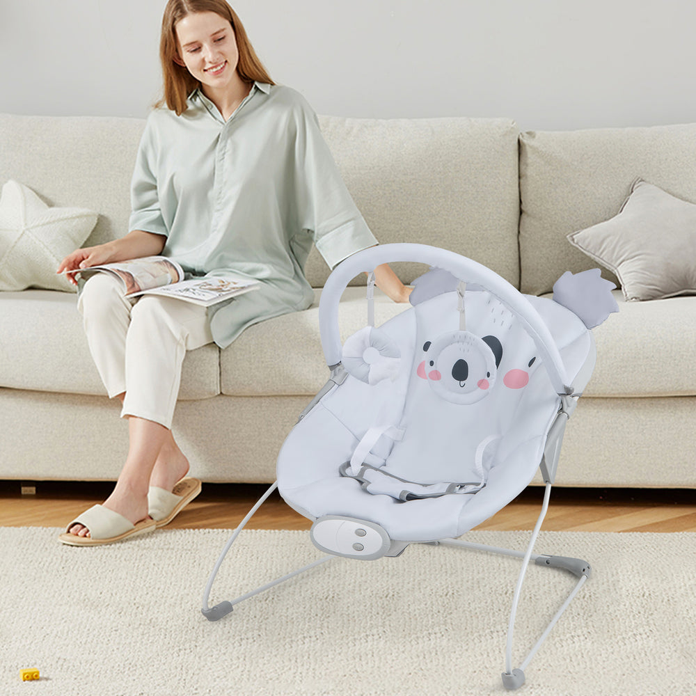 Portable baby bouncer rocker seat in gray with detachable toy bar, designed for comfort and safety, perfect for infants.