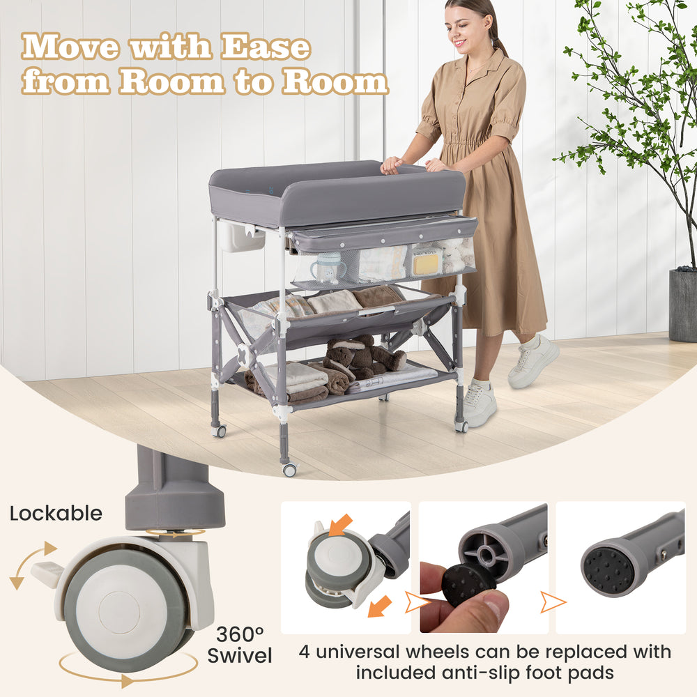 Portable baby changing table in gray with 360° swivel wheels and large storage rack for easy mobility and convenience.