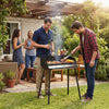 Portable charcoal grill with detachable legs, adjustable grate, and carrying bag, ideal for outdoor cooking and.