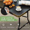 Portable folding camping table with a black HDPE tabletop, designed for easy setup and stability, ideal for outdoor use.