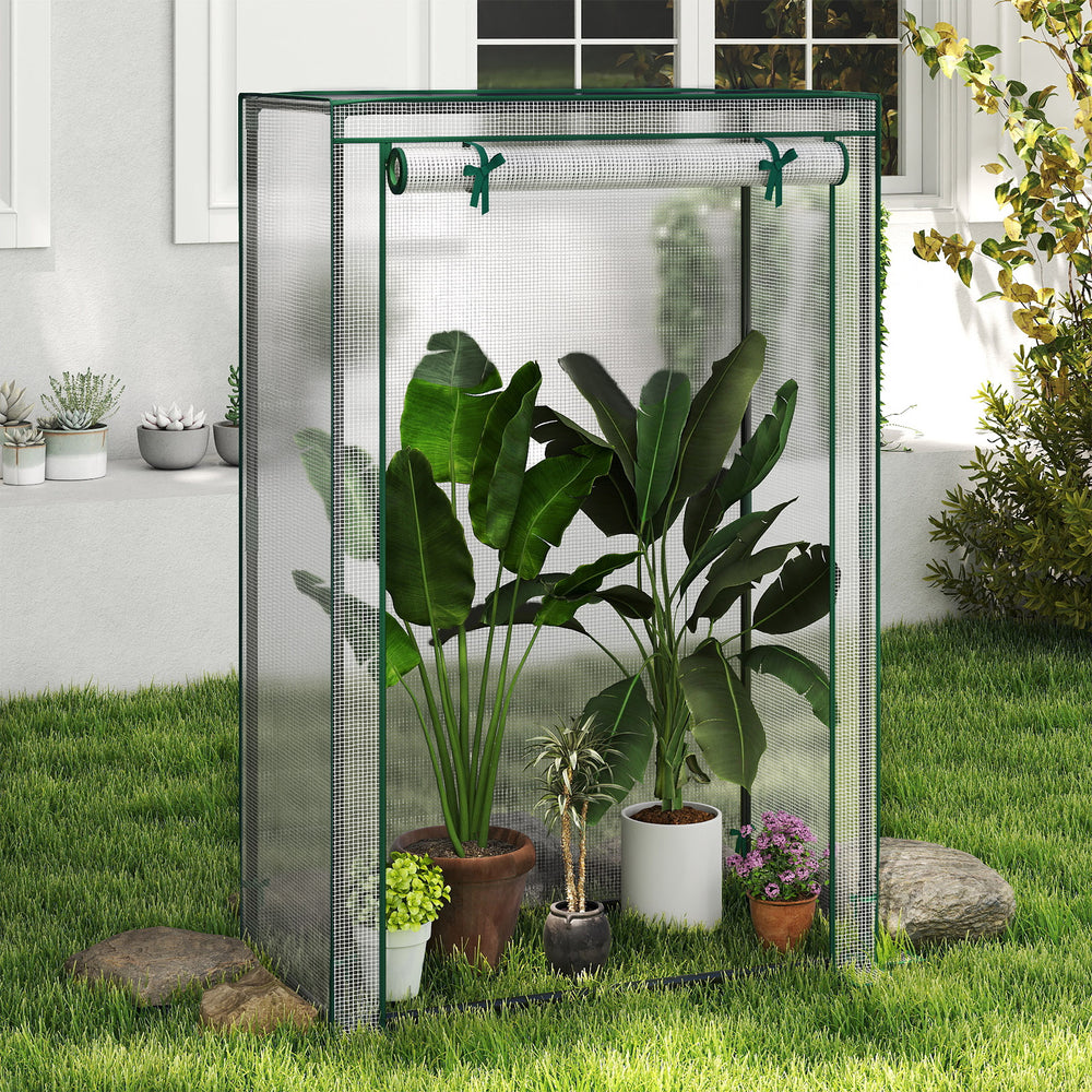 Portable mini greenhouse showcasing the roll-up zippered door and plants inside, designed for optimal sunlight exposure.