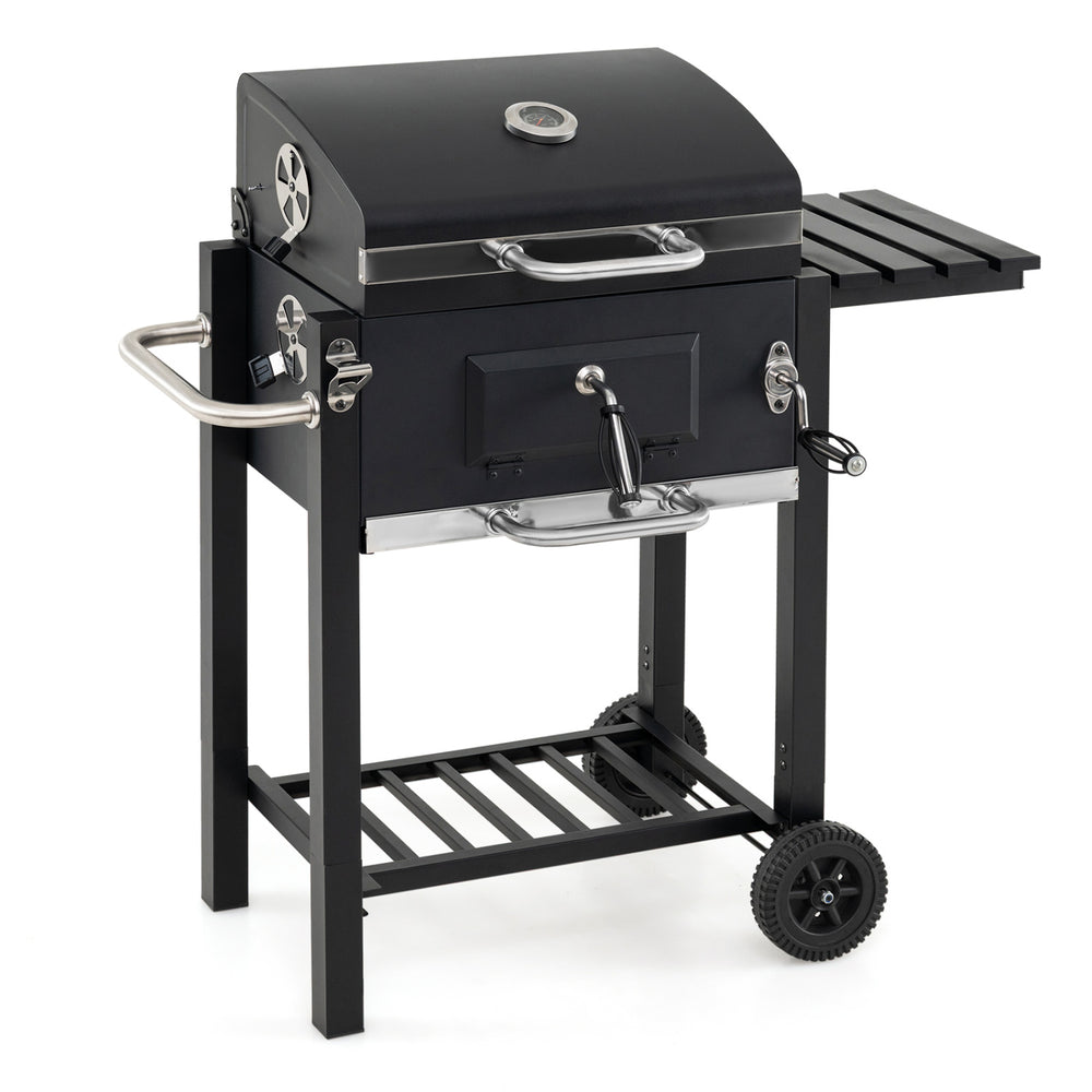 Portable charcoal grill with wheels, adjustable tray, and foldable side tables for outdoor cooking and picnics.