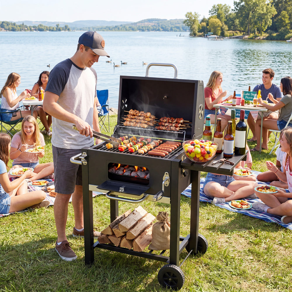 Portable outdoor barbecue grill in black with adjustable charcoal tray, wheels, and large cooking area for outdoor.