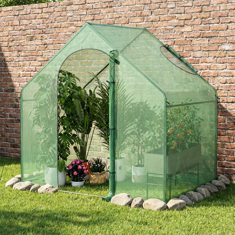 Portable outdoor warm house with PE cover, showcasing plants inside, designed for stability and easy air circulation.