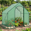 Portable outdoor warm house with PE cover, zippered door, and sturdy metal tubes for year-round plant protection.
