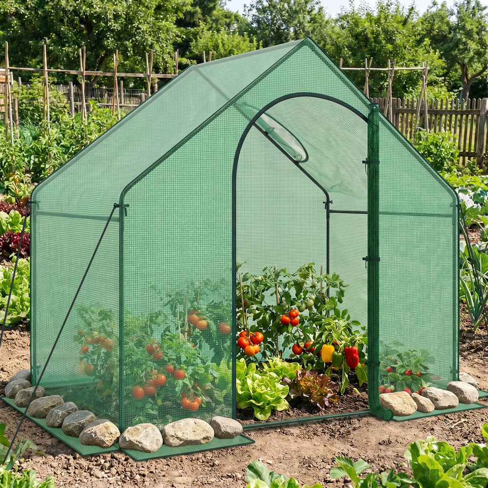 Portable outdoor warm house with PE cover, zippered door, and sturdy metal tubes for year-round plant protection.