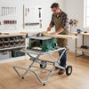 Portable table saw stand in use, showcasing its sturdy metal base and adjustable components for versatile woodworking tasks.