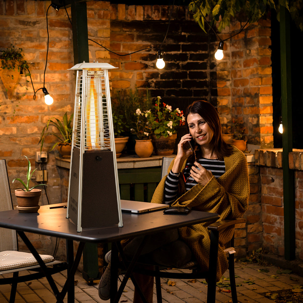 Portable steel tabletop patio heater with glass tube, 10000 BTU, providing 360° heat for outdoor gatherings.