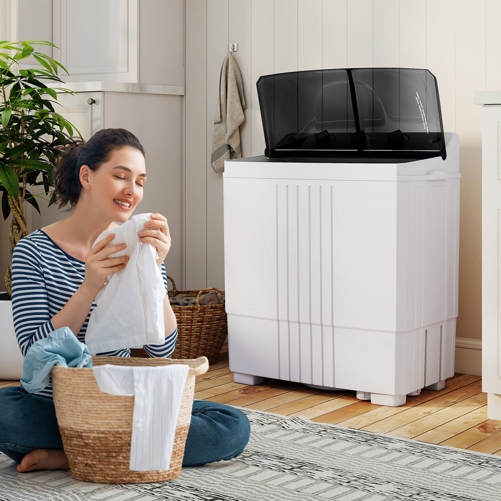 Portable washing machine with built-in drain pump, 12 lbs capacity, ideal for home and RV use, shown in a cozy laundry.