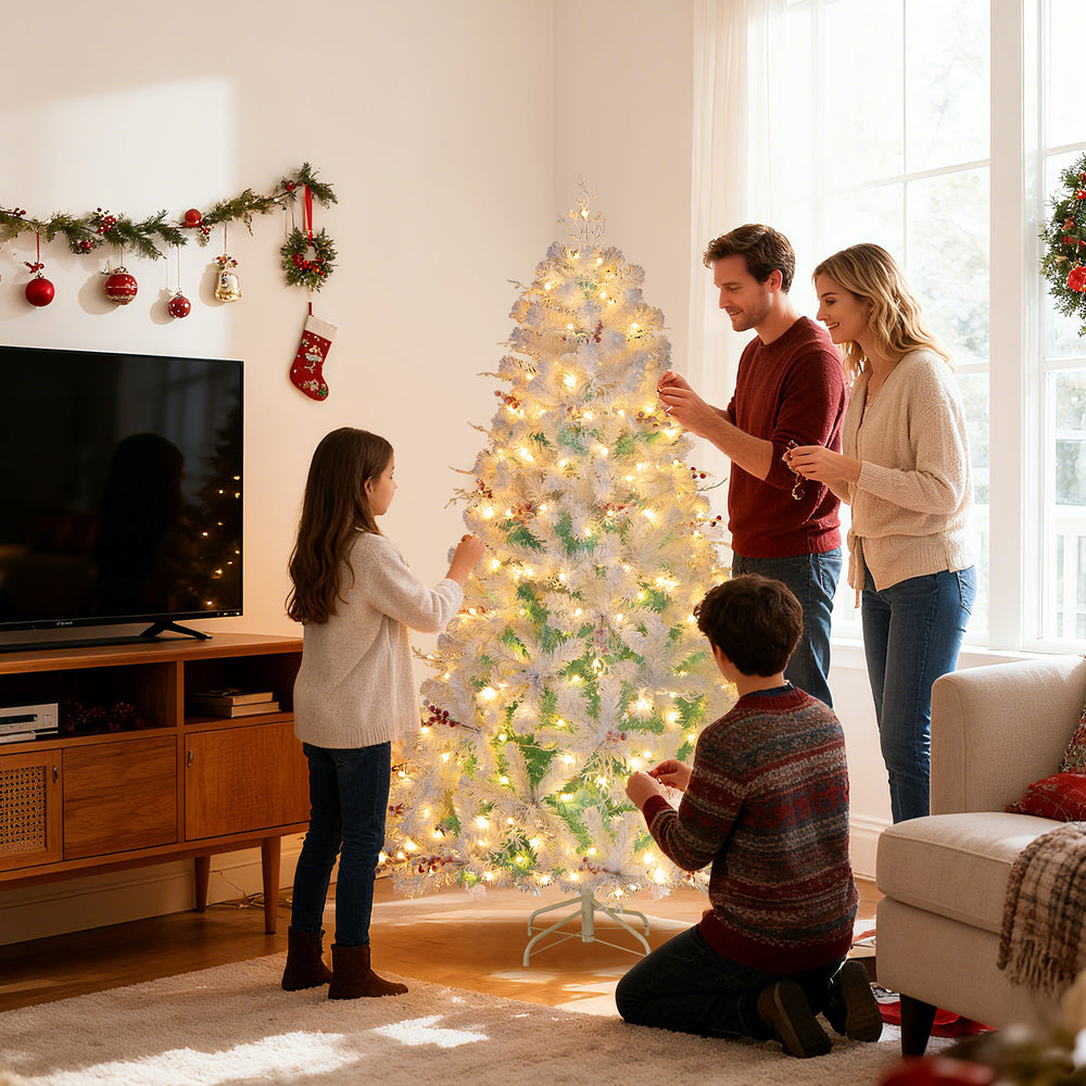 Pre-lit artificial Christmas tree with snow flocked branches, adorned with red berries, set up for festive decorating.