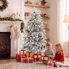 Frosted pre-lit artificial Christmas tree with warm white LED lights and festive gifts for a cozy holiday setting.