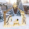 Pre-lit artificial crystal Holy Family decoration with warm white LED lights, star top, and door design in a snowy yard.