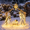 Pre-lit artificial crystal Holy Family decoration with warm white LED lights, top star, and door design in a snowy yard.