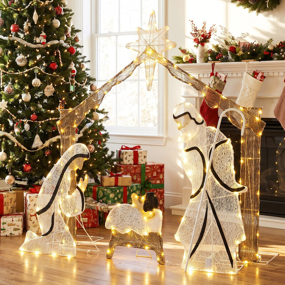 Pre-lit artificial crystal Holy Family decoration with warm white LED lights, shown in a festive indoor nativity scene.