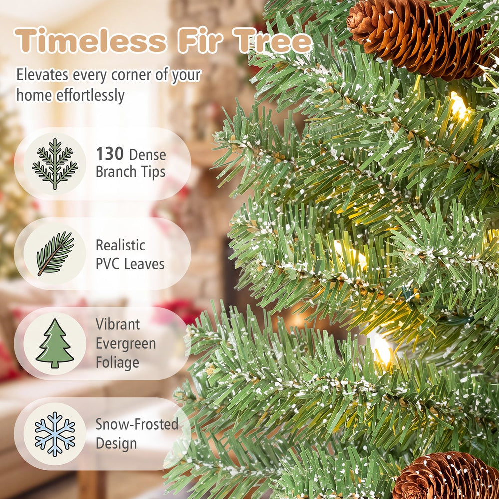 Pre-lit mini Christmas tree with snow-dusted tips and pine cones glows with warm white LED lights for festive small spaces.