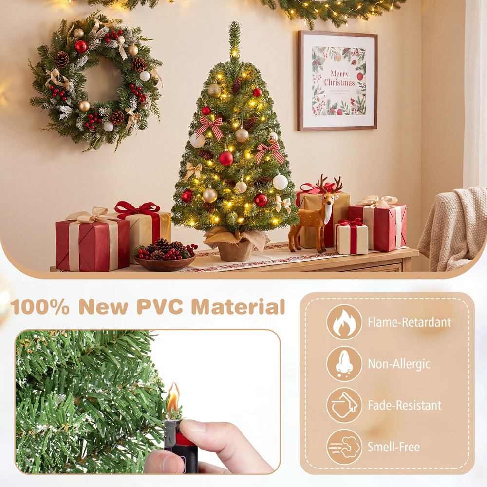 Pre-lit mini Christmas tree with 50 warm white LED lights, shown decorated with ornaments beside holiday gifts.